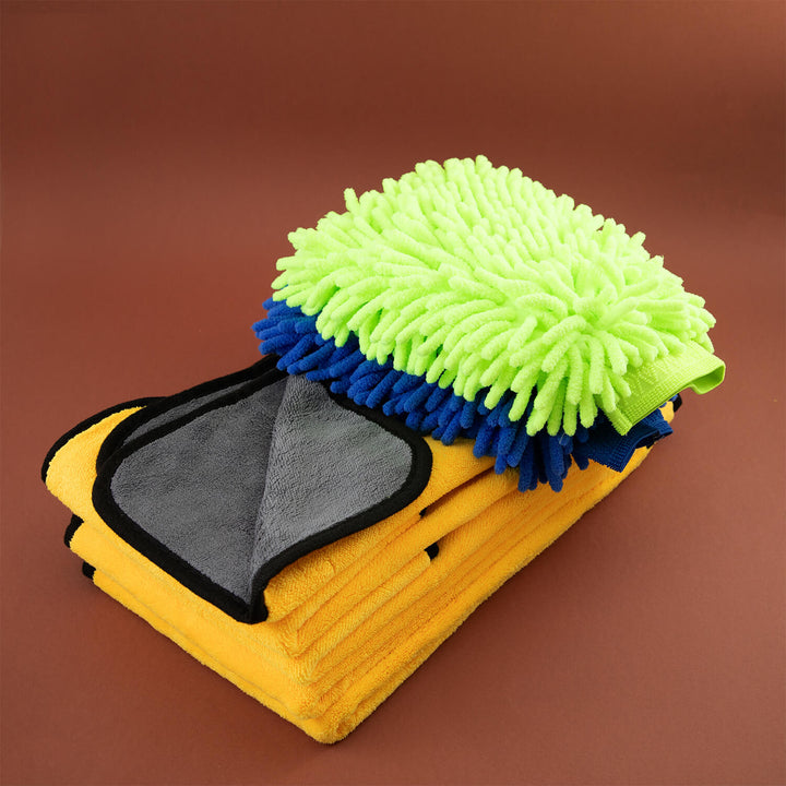 Multicolored microfiber cleaning cloths, cleaning supplies, microfibre with green, blue, and gray sections on a brown background