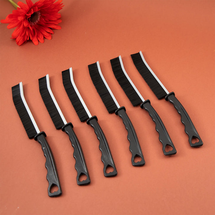 Set of black and white crevice cleaning tools, cleaning brush, cleaning supplies, microfibre with white blades on a brown background