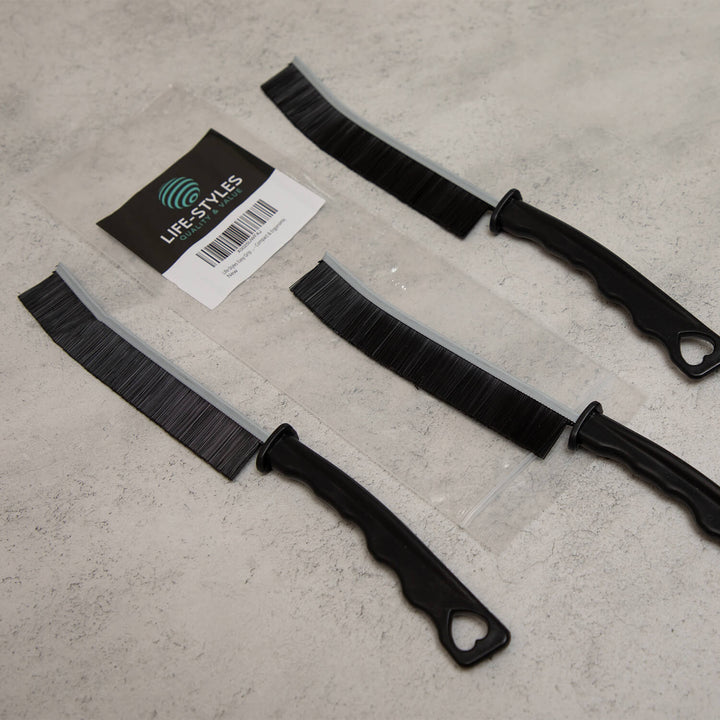 Three black crevice cleaning tools, cleaning supplies, microfibre cleaning cloths with sheaths on a gray surface, featuring a 'Lifestyles' label.