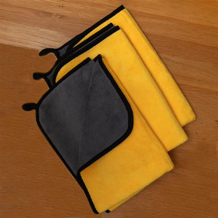 Set of yellow and gray microfibre cloths, microfibre, cleaning cloths, cleaning supplies on a wooden surface