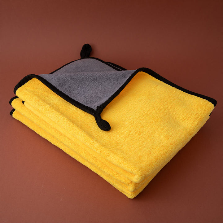 Stack of yellow and gray microfibre cleaning cloths, cleaning supplies, cleaning cloths, microfibre on a brown background